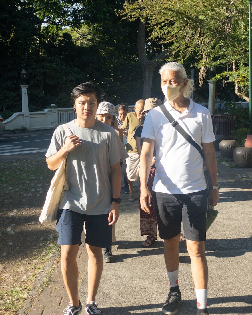 Two men walking in front of a group