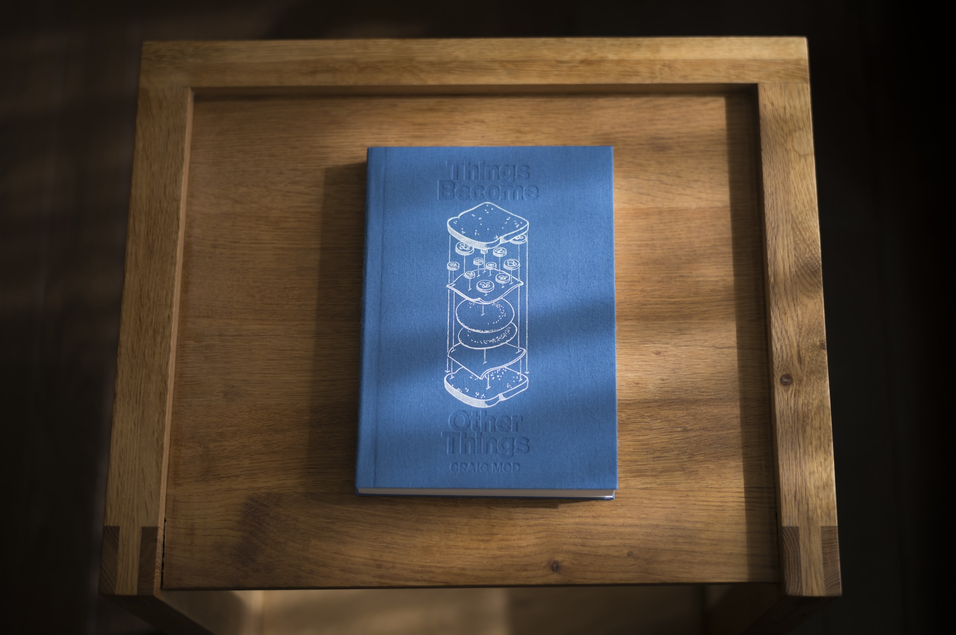 A blue book on a wooden tray