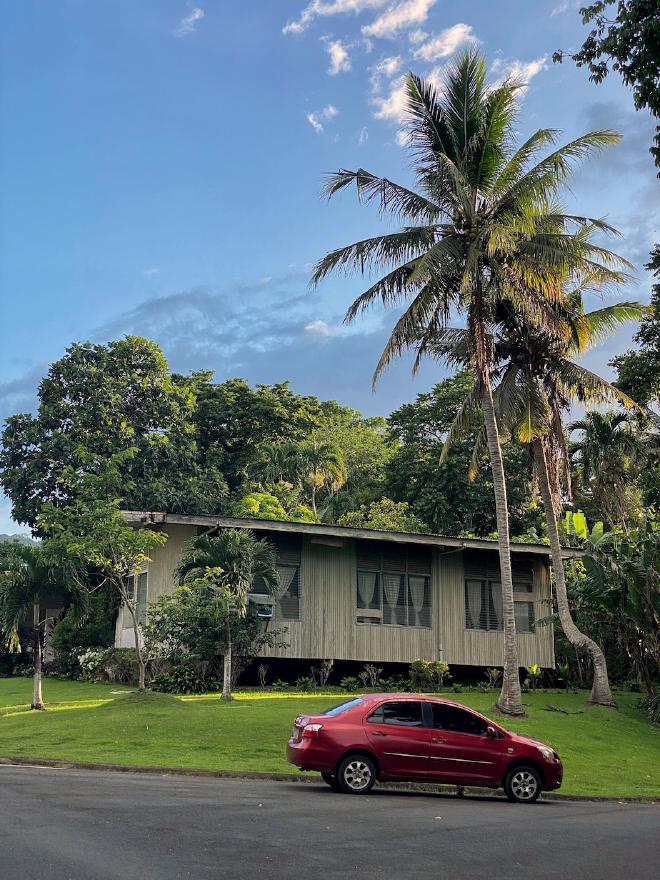 A red car in front of a house