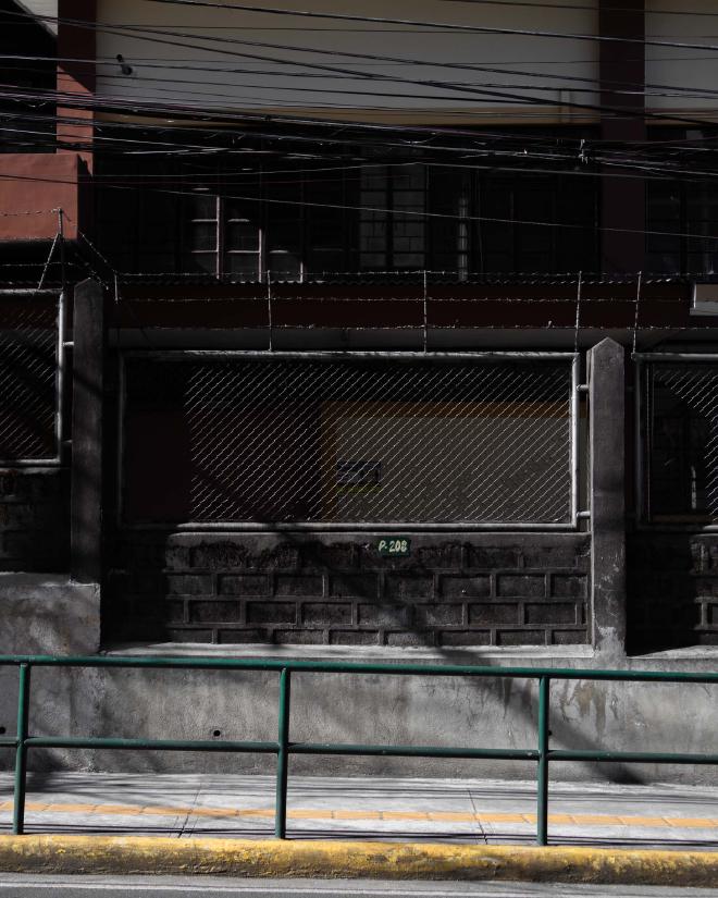 A sidewalk outside a fence