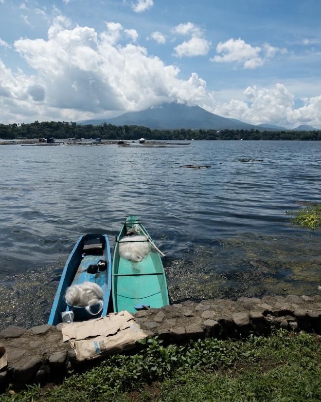 Two boats on dock overlooking a mountain